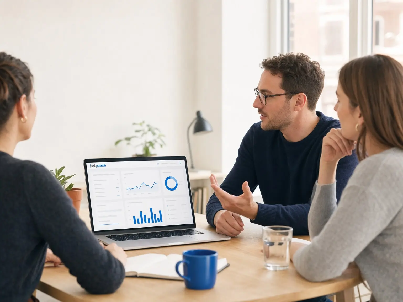 An AdSmith account strategist walking two clients through their campaign numbers.