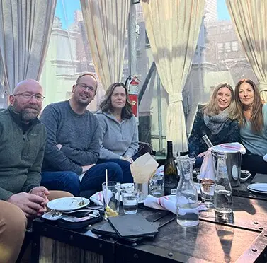 360 Media Direct teammates seated together at a rooftop dinner.
