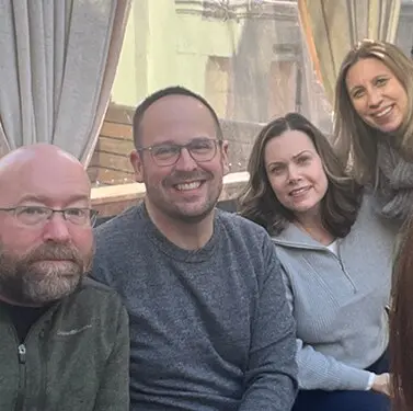 360 Media Direct teammates posing together at a restaurant.