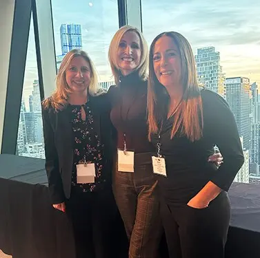 360 Media Direct teammates at an evening event overlooking a city skyline.